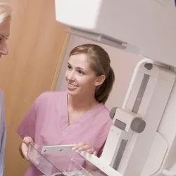 Mammogram technician with patient.
